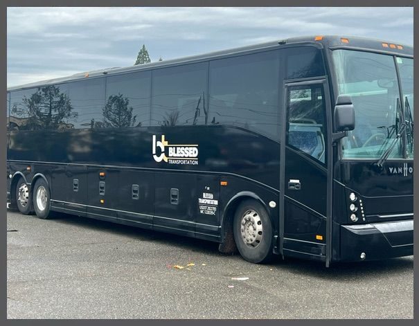 A black bus parked in the parking lot.