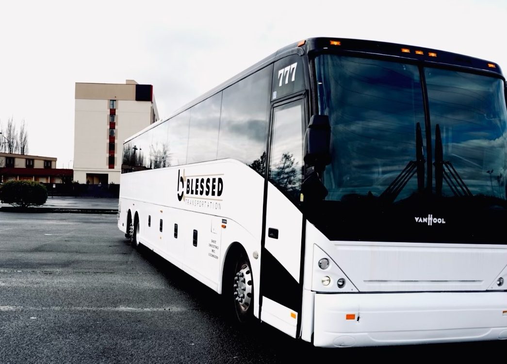 A white bus parked in the parking lot.